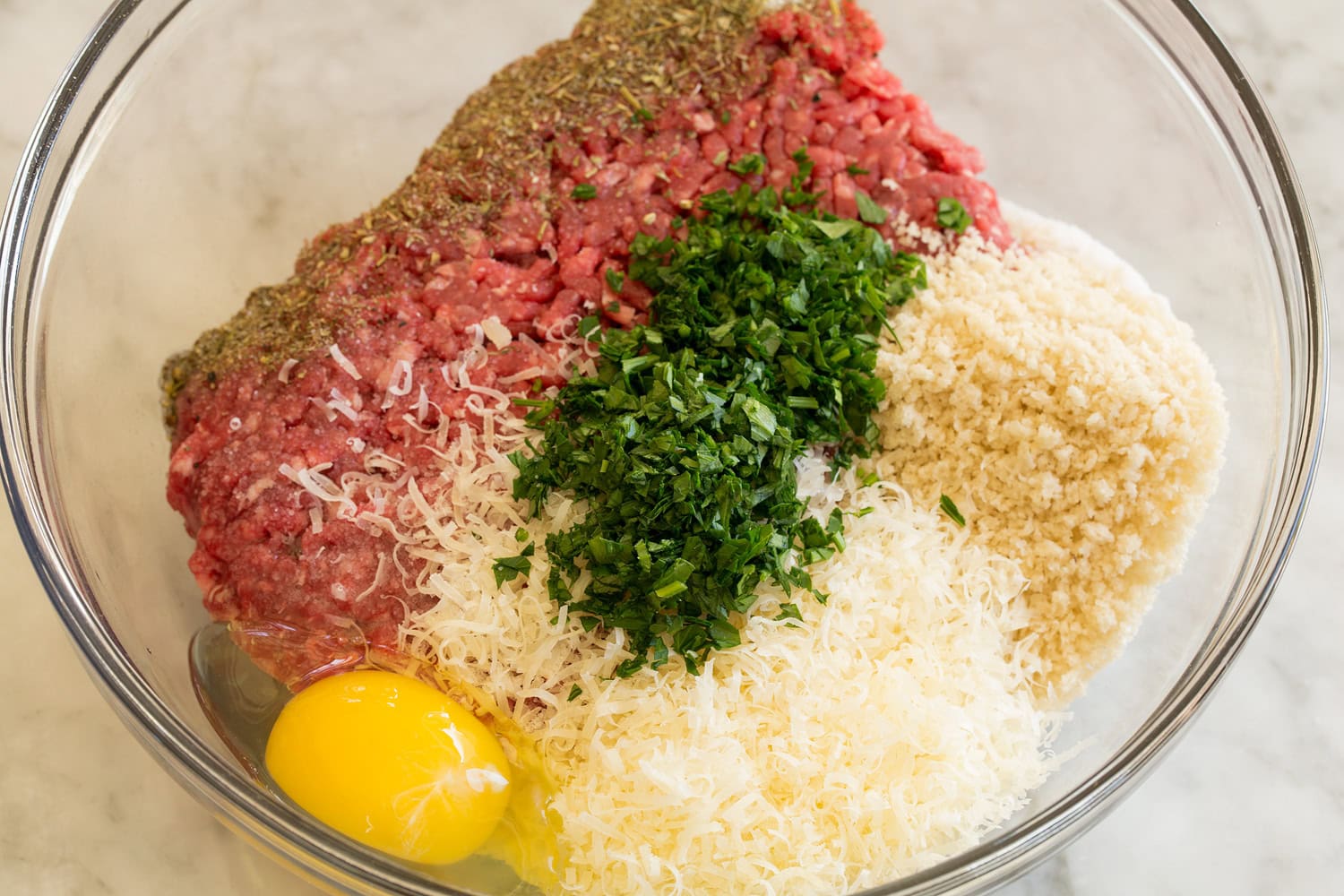 Meatball Soup Meatball mixture before mixing in a glass mixing bowl.