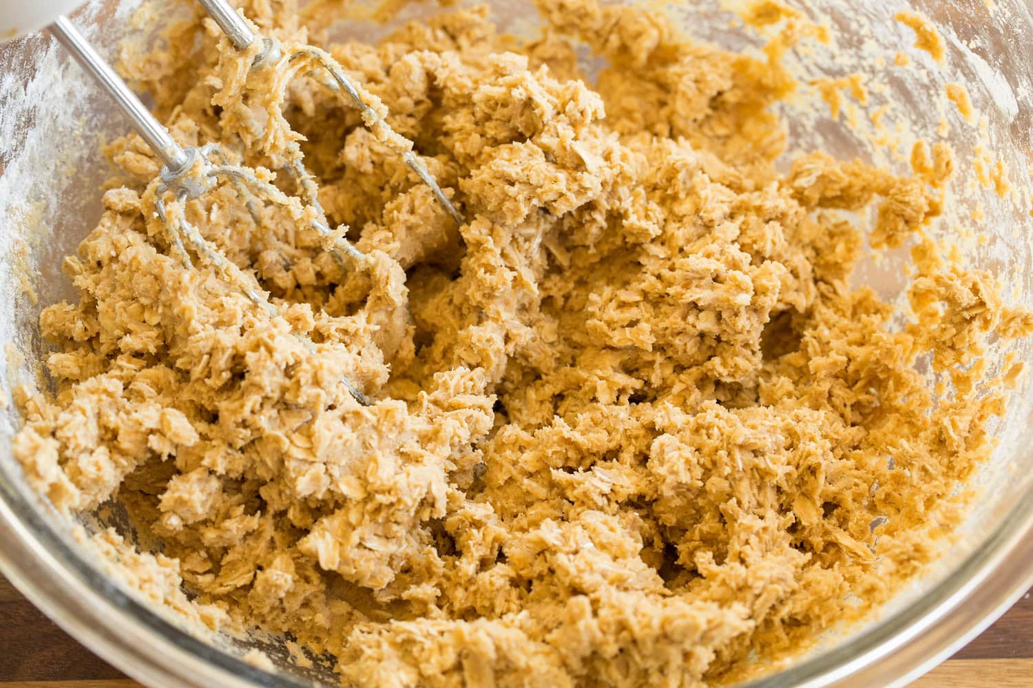 Oatmeal Cream Pies Blended oatmeal cookie dough in glass mixing bowl.