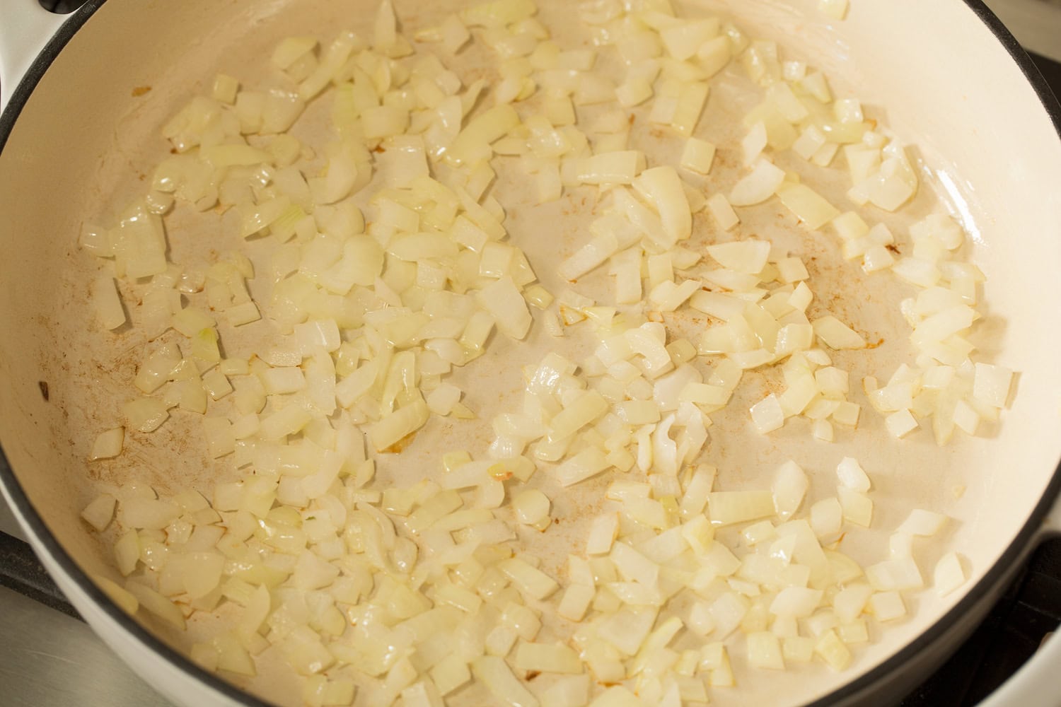 Taco Pasta Sauteing onions in skillet.