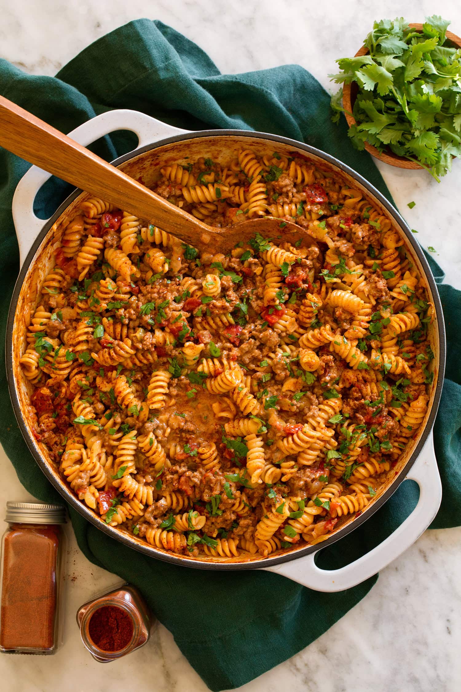 Taco Pasta Taco pasta in a grey skillet over a green cloth on a marble surface.