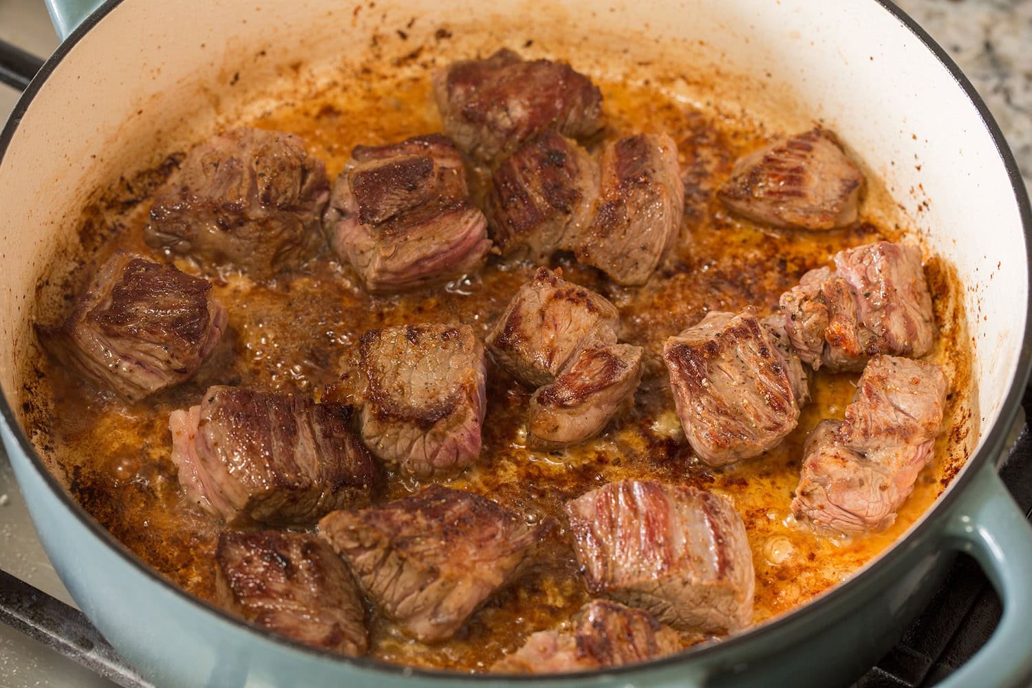 Beef Bourguignon Beef chuck chunks shown after searing and browned in a pot.