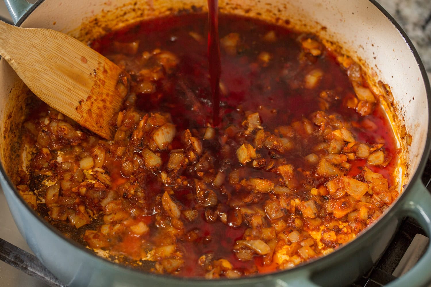 Beef Bourguignon Red wine poured into pan.
