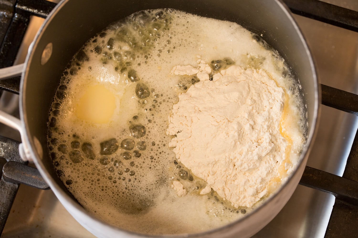Coq au Vin Making roux with flour and melted butter.