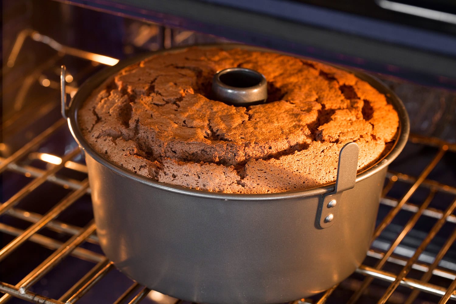 Chocolate Angel Food Cake Angel food cake pan in oven baking.