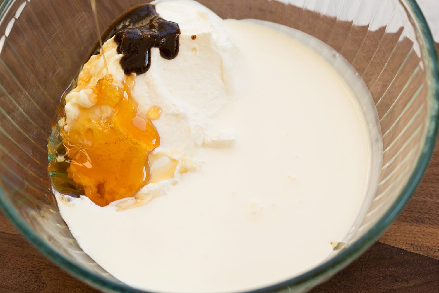 Whipped Yogurt Yogurt, cream, honey and vanilla bean in a mixing bowl.