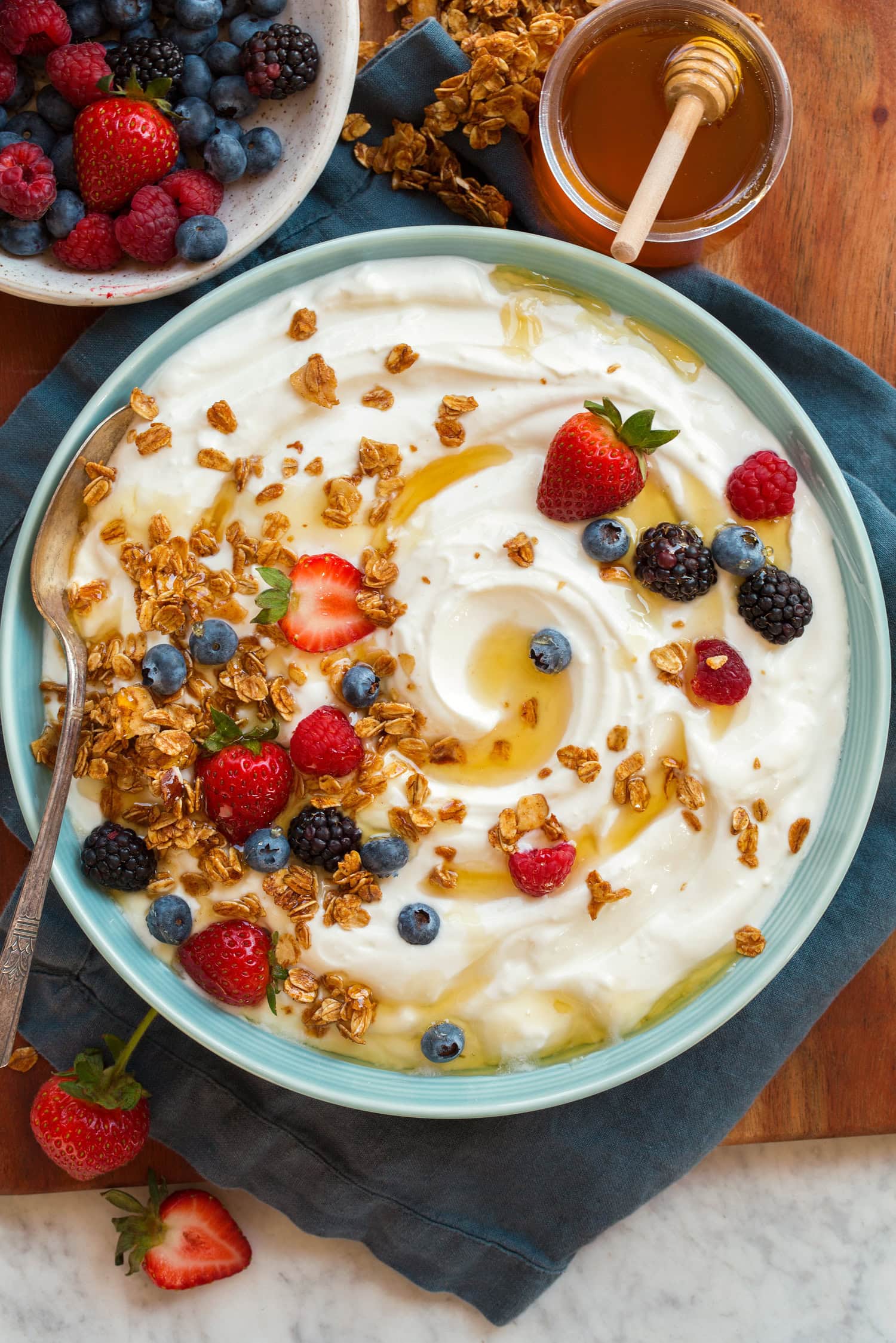 Homemade Yogurt Plain homemade yogurt with fruit and granola atop. Shown from overhead.