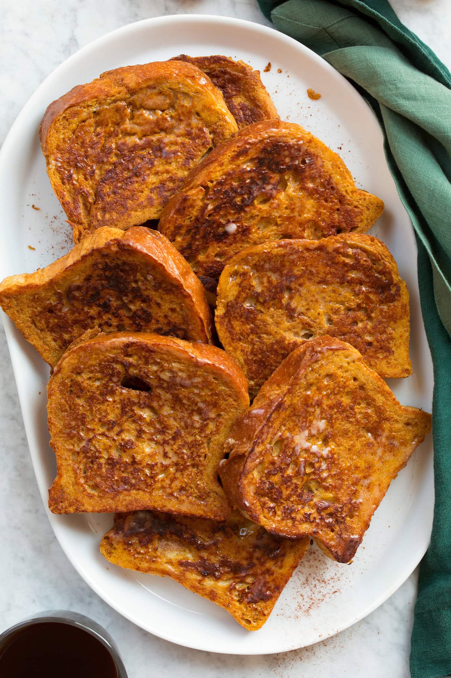 Pumpkin French Toast Plain pumpkin french toast without toppings shown overhead on an oval serving platter.